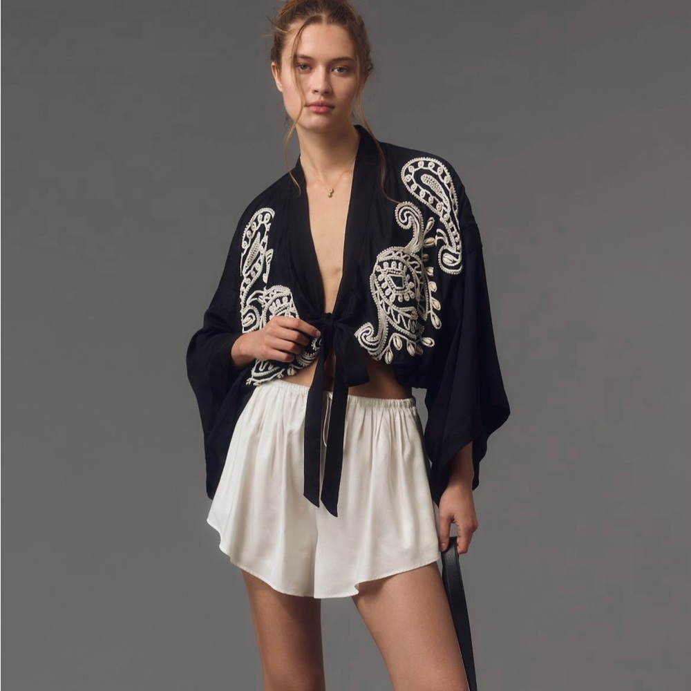 By Anthropologie embellished tie front top.
